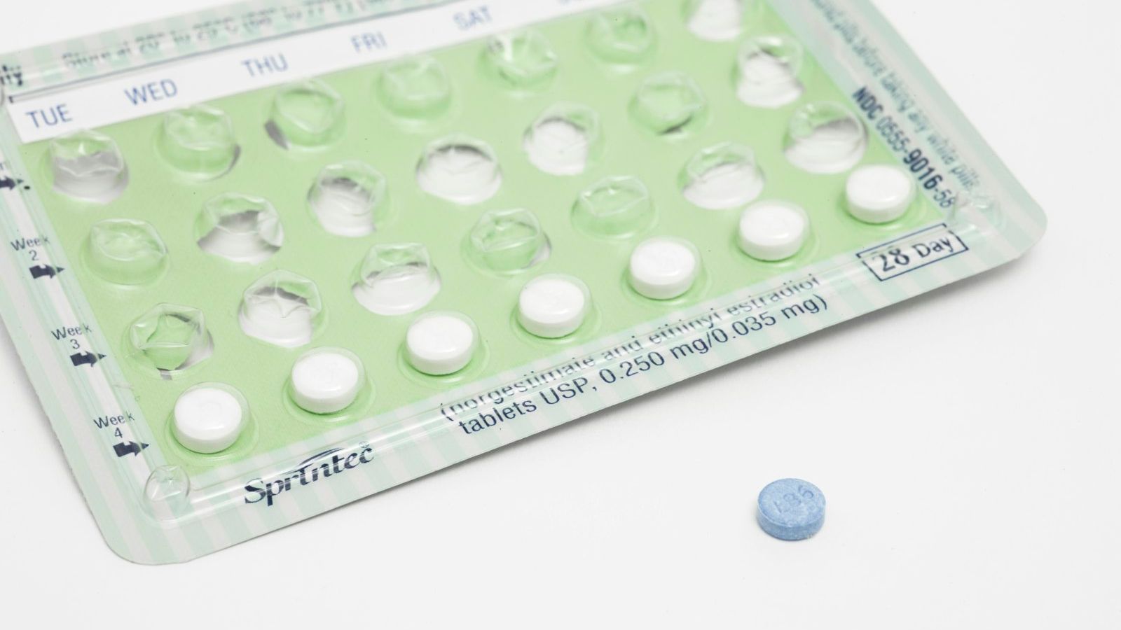 A partially used 28-day birth control pill pack on a plain white background