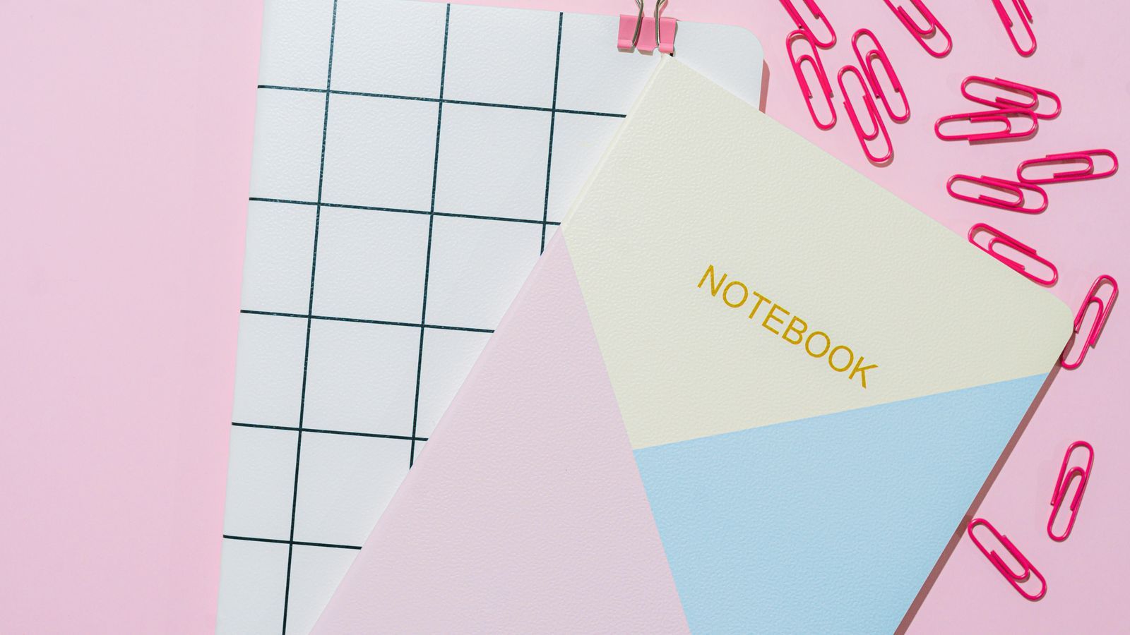 school backpack and notebook on a pastel desk with sunlight