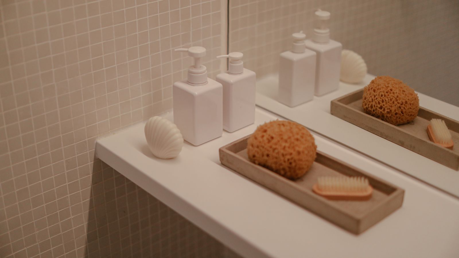 pastel silicone shapes arranged on a clean bathroom shelf