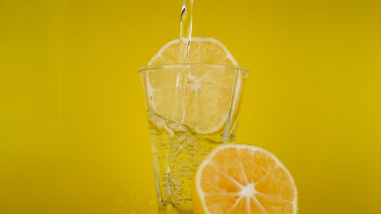 glass of water with lemon slice on a bright kitchen table