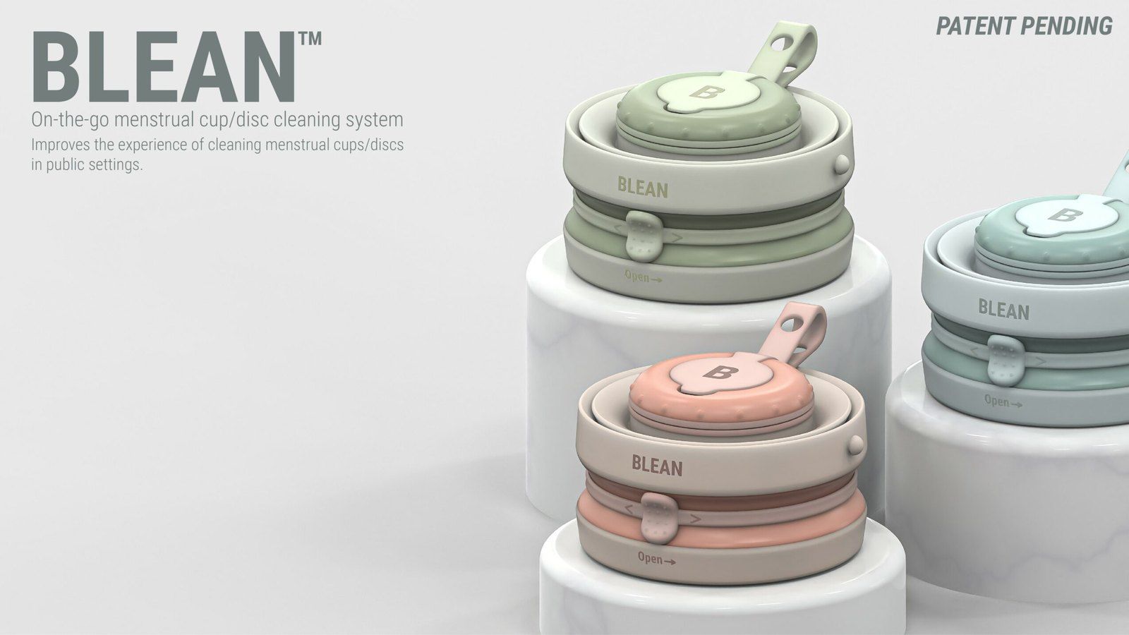Three Blean menstrual cup cleaning devices in sage green, cream and blush pink, stacked containers with a hanging loop, on white marble plinths